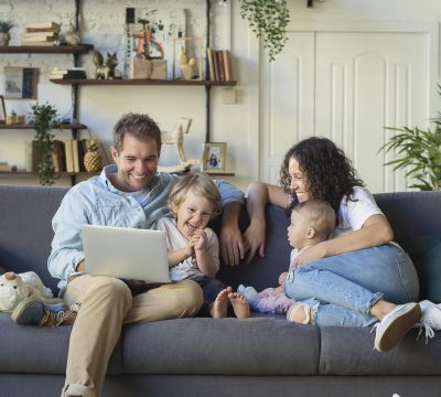 Young beautiful happy family relaxing at home