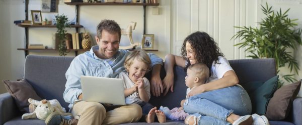 Young beautiful happy family relaxing at home